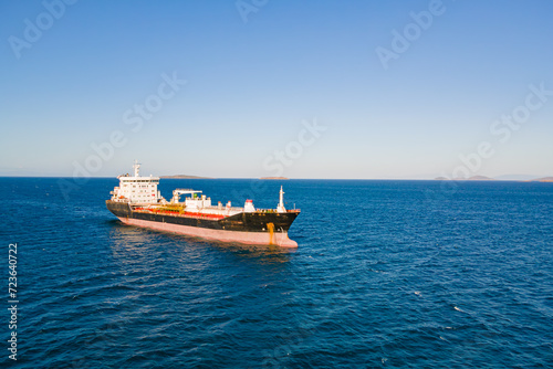 Petrochemical product cargo ship at anchorage in sea before loading on industrial terminal. Aerial view