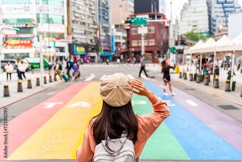 Young female tourist with Rainbow Road crossing at Ximending landmark and popular attractions in Taipei, Taiwan photo