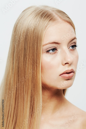 Young, model and beauty or cosmetic in studio, confident and cosmetology for facial skin treatment in wellness. Woman, glow or shine in self care or blonde hair or organic makeup by white background