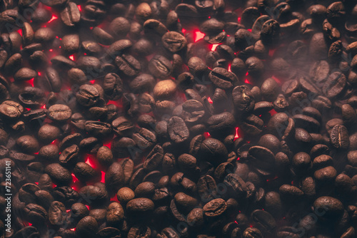 Roasted coffee beans with smoke and fire background. Close up,