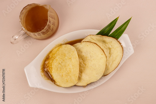 Serabi Kuah Kinca, Indonesian Traditional Pancake Made of Rice Flour and Coconut Milk Served with Thickened Palm Sugar Sauce. photo