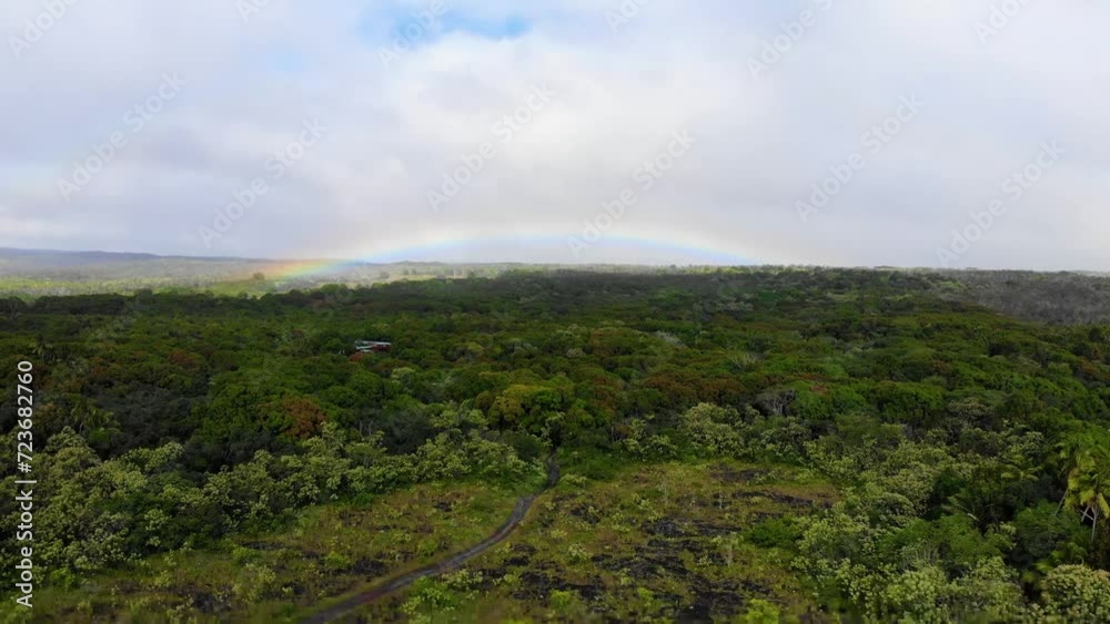 Slow glide over forest and road with rainbow Slow glide over forest and road with rainbow