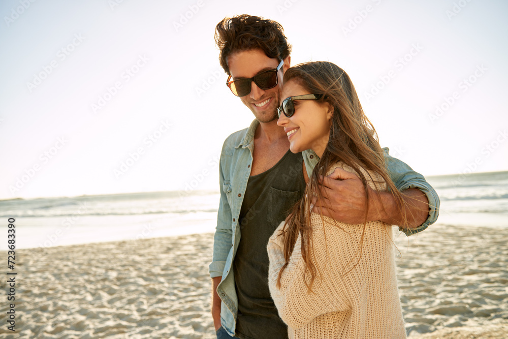 Happy, travel and couple hug at a beach with love, adventure and bonding in nature together. Care, comfort and people embrace at the sea for ocean view, summer and romance on Miami vacation trip