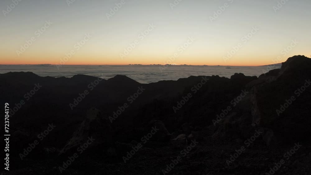 View over clouds from Haleakala volcano at sunset on Maui, Hawaii View over clouds from Haleakala volcano at sunset on Maui, Hawaii