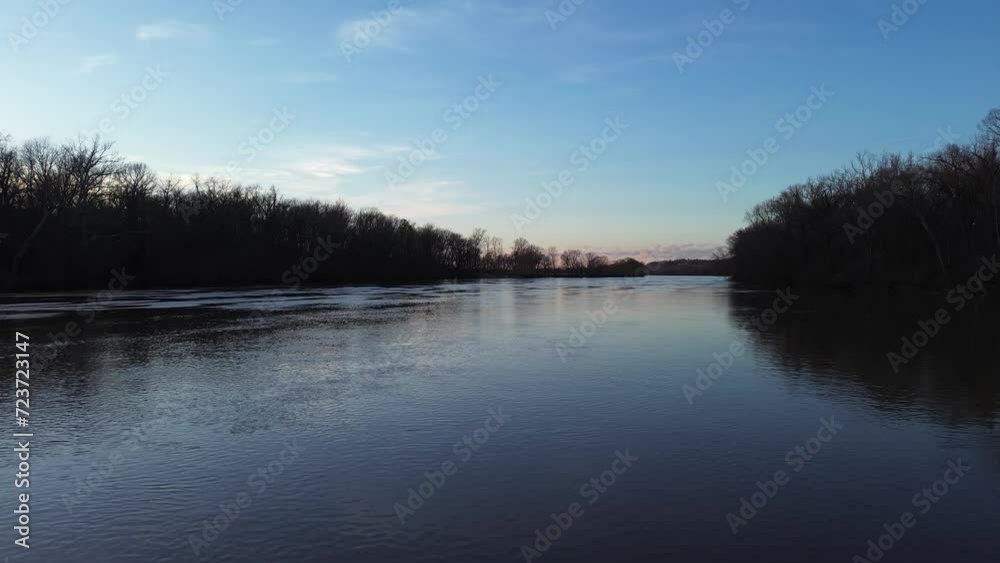 Drone shot over still James river water surface in cold winter morning. Drone shot over still James river water surface in cold winter morning.