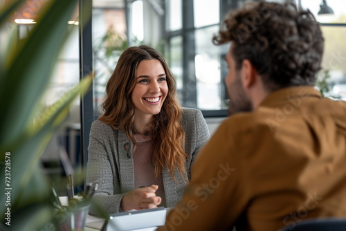 Happy businesswoman interviewing a well-prepared job candidate in a cozy office environment. The job interview process - from expectation to excitement, captured in high-definition