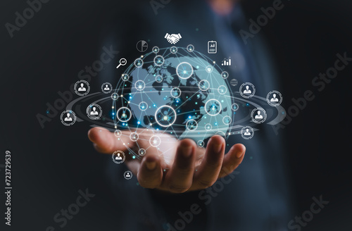 businessman holding Global network connection. Big data analytics and business intelligence concept. World map point and line composition concept of global business.Digital link tech.