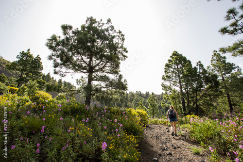 A young woman walking towards Birigoyo peak, La Palma Island, Canary Islands.