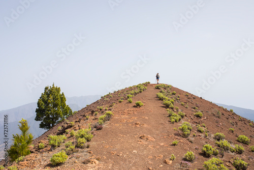 A young woman walking towards Birigoyo peak, La Palma Island, Canary Islands. photo