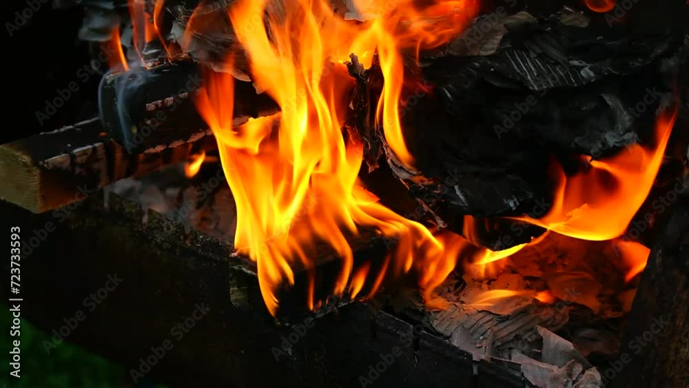 burning wood and paper. firewood is burning. tongues of flame. orange flame. bonfire. wood-fired cooking. firewood is burning for cooking barbecue burning wood and paper. firewood is burning. tongues of flame. orange flame. bonfire. wood-fired cooking. firewood is burning for cooking barbecue