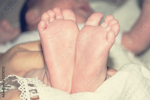 Children's little legs. A newborn baby. Baby's little fingers. Part of the baby's body