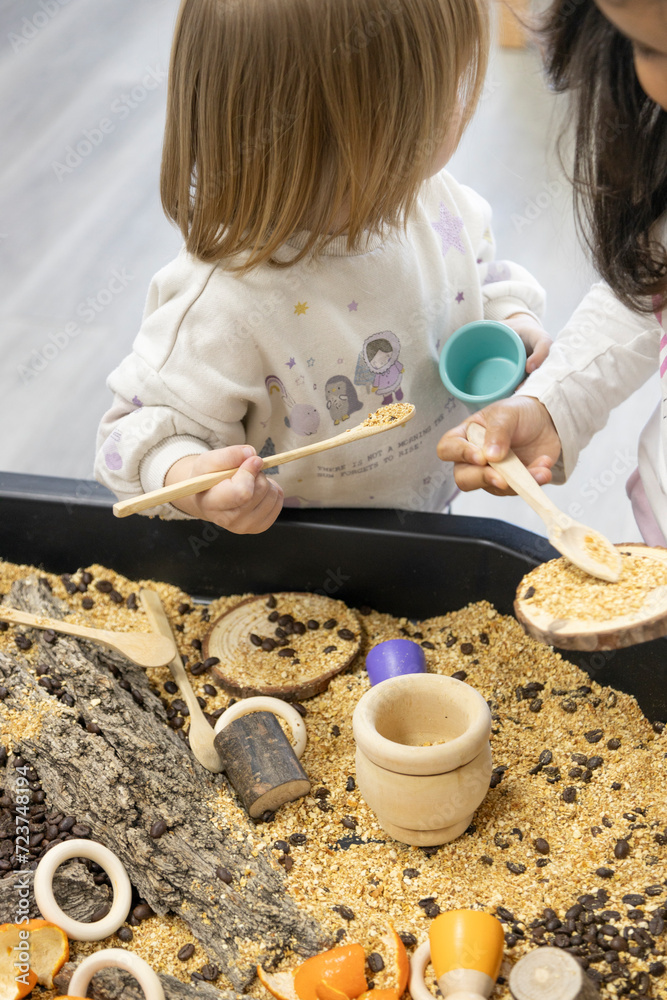 unrecognizable little children manipulating natural materials on a work ...