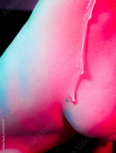 body woman back in red and teal with lubricant liquid