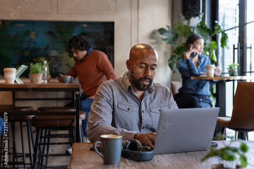 African American male freelancer working from a cafe photo