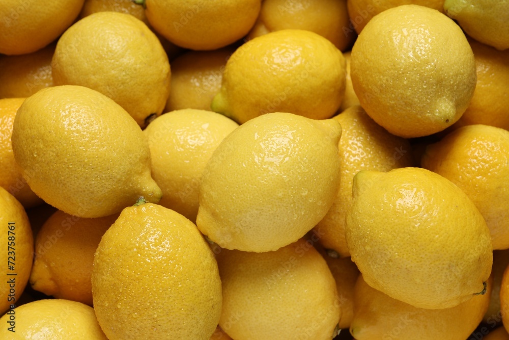 Fresh lemons with water drops as background, closeup Fresh lemons with water drops as background, closeup