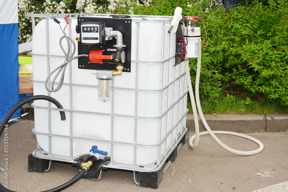 Portable fuel tank with pipes, pump and measuring meter. Mini portable diesel storage tank station. Portable fuel tank with pipes, pump and measuring meter. Mini portable diesel storage tank station.