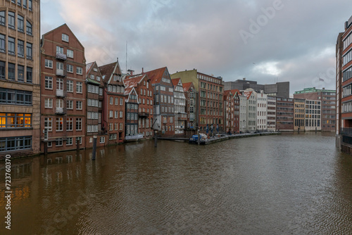 Germany's second largest city Hamburg streets canals and symbolic buildings snow and colorful cloudy sky and daylight in winter © Aytug Bayer