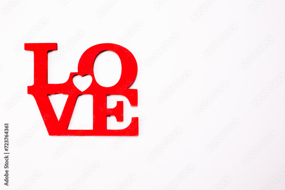 The word love in wooden red letters on white background. Valentine's day, Mother's Day, March 8 holiday card concept The word love in wooden red letters on white background. Valentine's day, Mother's Day, March 8 holiday card concept