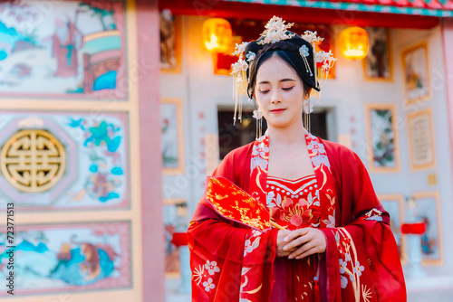 Woman dress China New year. portrait of a woman. person in traditional costume. woman in traditional costume. Beautiful young woman in a bright red dress and a crown of Chinese Queen posing.