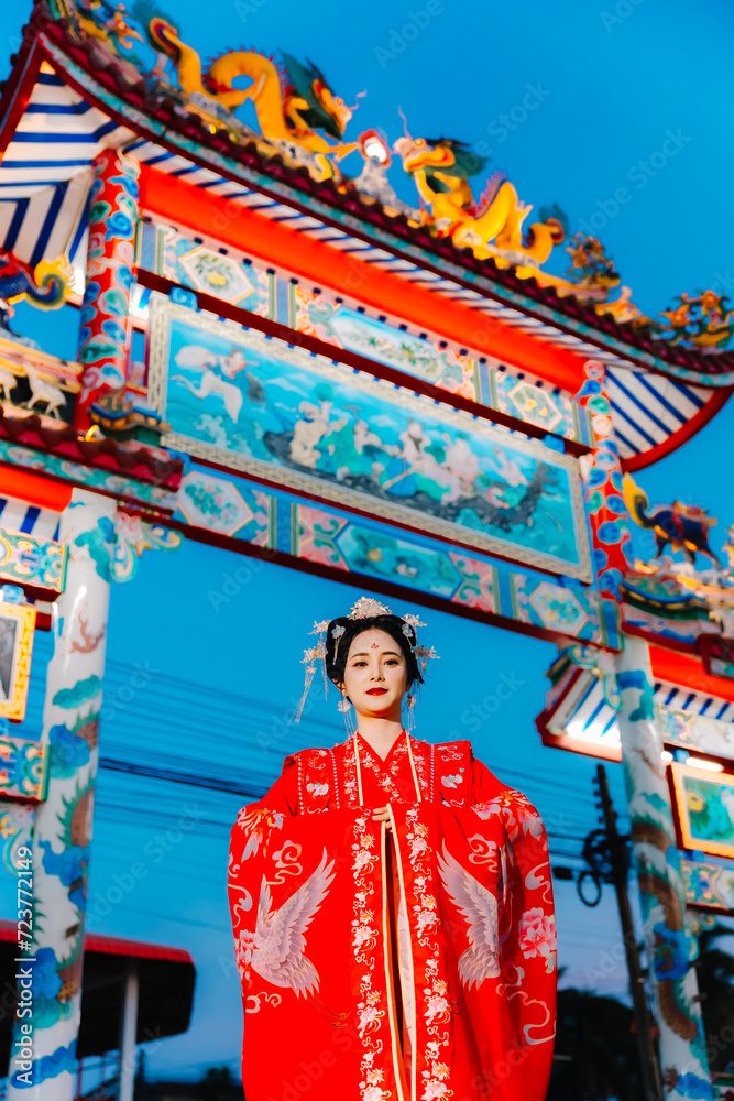 Fototapeta premium Woman dress China New year. portrait of a woman. person in traditional costume. woman in traditional costume. Beautiful young woman in a bright red dress and a crown of Chinese Queen posing.