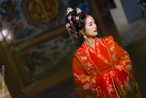 Woman dress China New year. portrait of a woman. person in traditional costume. woman in traditional costume. Beautiful young woman in a bright red dress and a crown of Chinese Queen posing.