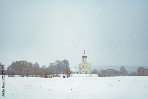 a church in winter in the middle of a snow-covered field