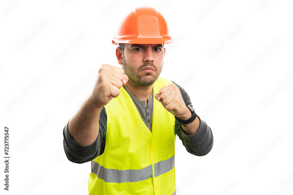 Angry male builder showing fists as fighting gesture