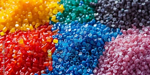 Colourful plastic masterbatch granules as a textured background.