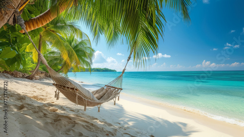 Empty hammock hanging on palm trees  Tropical beach and landscape background   summer relax travel
