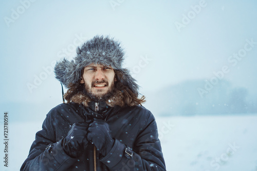 a bearded man in an earflap in winter