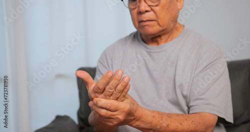 Asian man has tingling and numbness in his hand which causes beriberi. © ronnarong