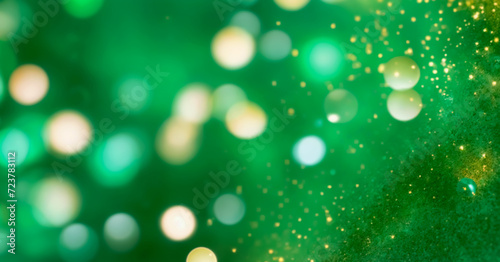 Gold bokeh on defocused emerald green background © big bro