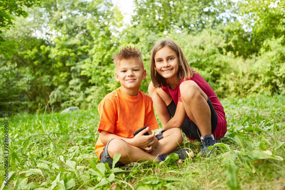 Fototapeta premium Portrait of smiling boy and girl at park