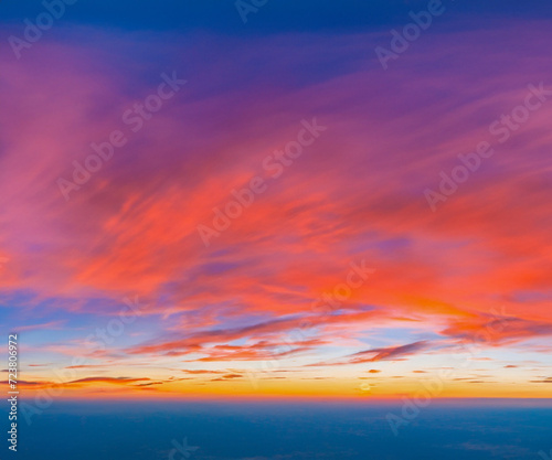 Ideal for Sky replacement project  colorful pink-orange-blue dramatic sky with clouds illuminated by red sunset  aerial photography  far horizon without obstacles.