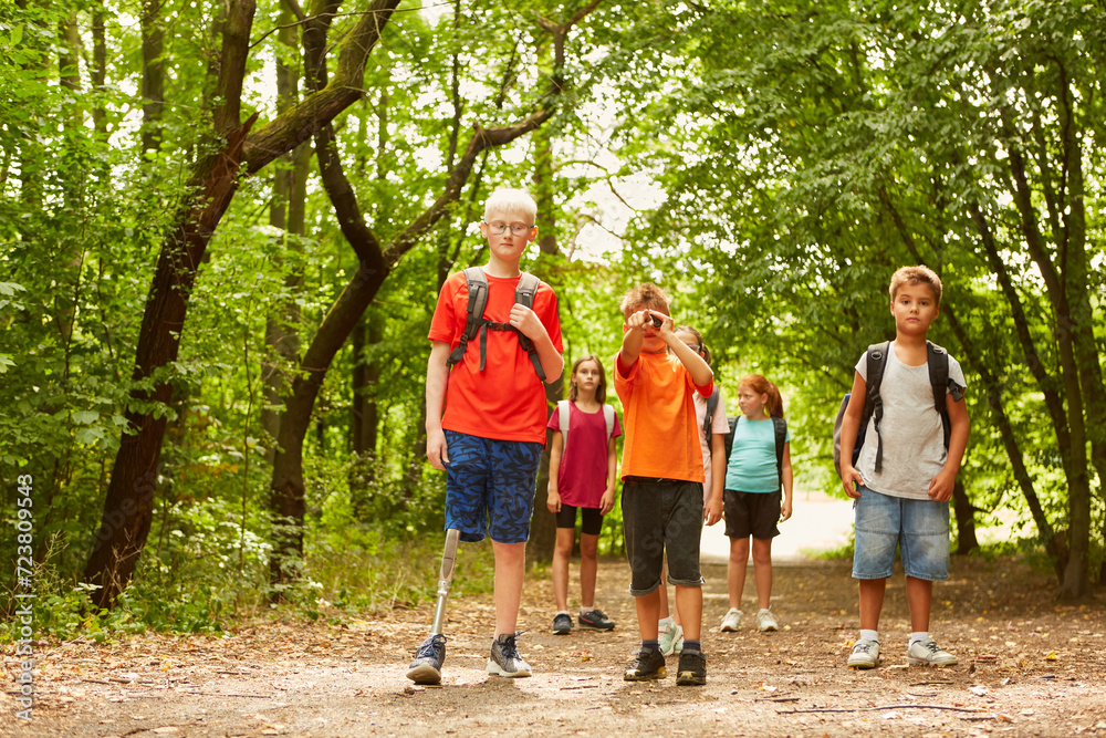 Fototapeta premium Boy exploring forest with friends