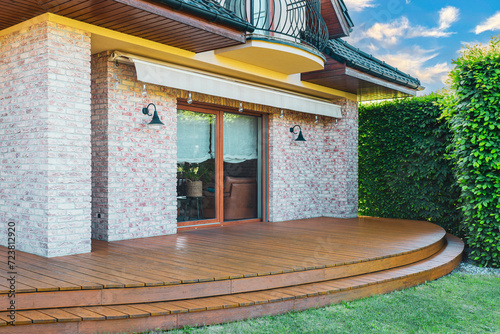 Luxury villa exterior with garden terrace and wooden exotic floor. photo