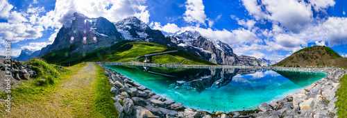 Switzerland nature .  panoramic view of Fallboden lake with turquoise water and reflections of snowy peaks. Kleine Scheidegg mountain pass famous for hiking in Bernese Alps. Swiss travel