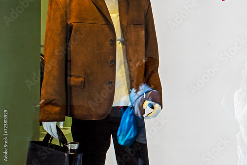 stylish brown men's jacket with a man purse in a clothing store window. Style and fashion
