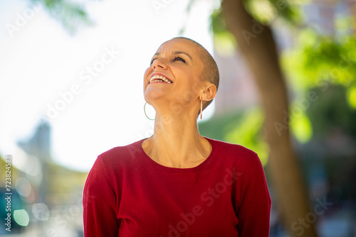 older woman with shaved head laughing photo