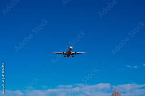 Airplane against clear blue sky