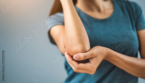 woman's elegant elbow, gracefully holding open skin in a pristine studio background in pain, emphasizing beauty and vulnerability