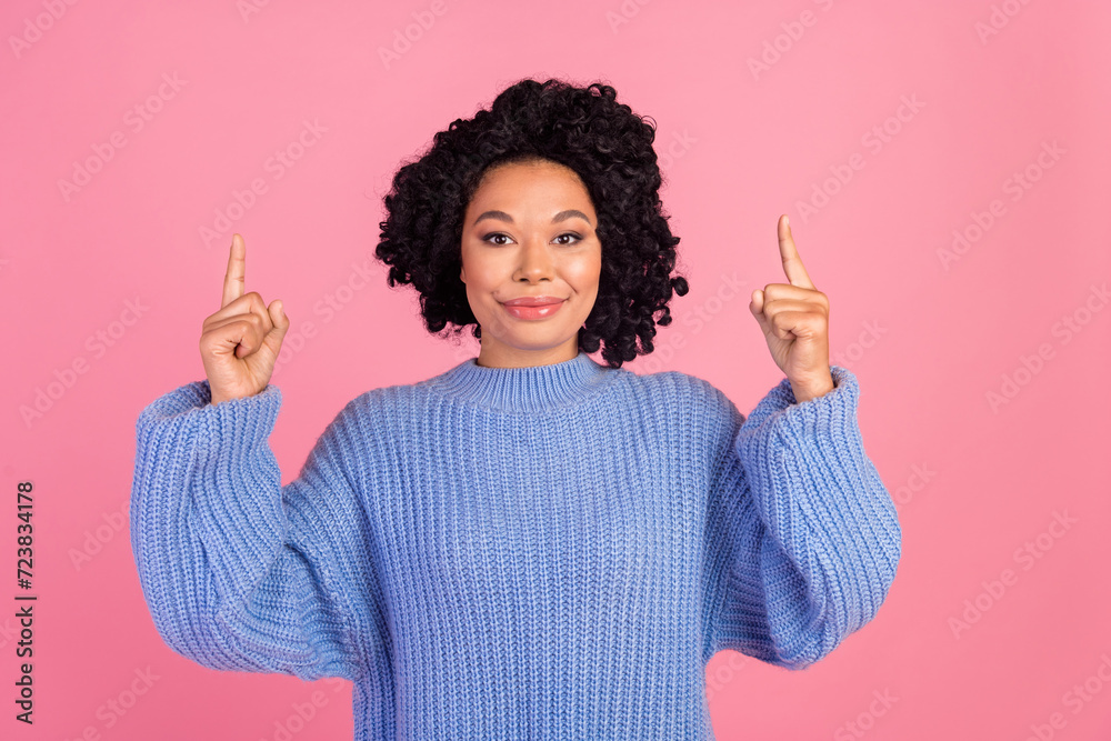 Photo of attractive young woman point up empty space dressed stylish blue knitwear clothes isolated on pink color background Photo of attractive young woman point up empty space dressed stylish blue knitwear clothes isolated on pink color background