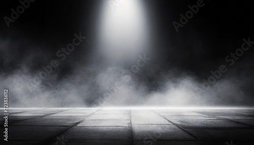 empty space of studio dark room with spot lighting and fog or mist on concrete floor in black background