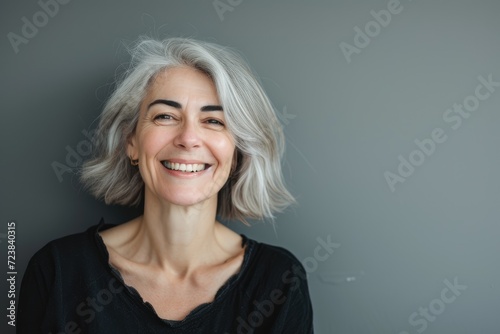 Beautiful gorgeous 50s mid age beautiful elderly senior model woman with grey hair laughing and smiling. Mature old lady close up portrait. Healthy face skin care beauty, skincare cosmetics, dental Ai