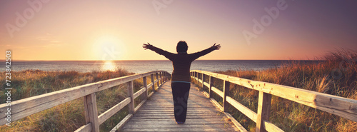beautiful view at the sea ,senior woman on a wooden jetty at lake