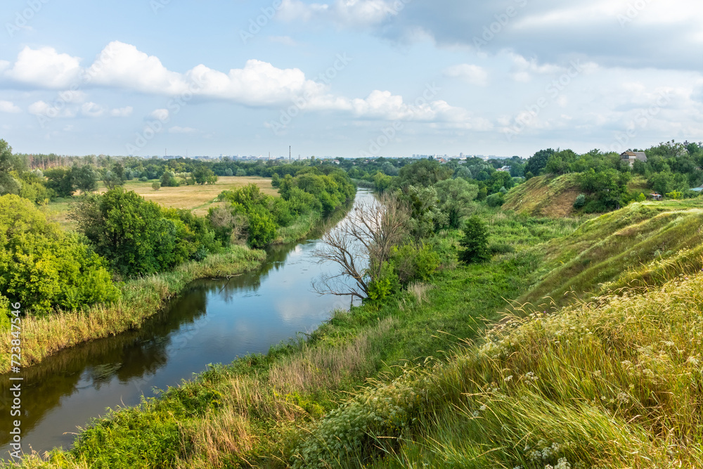 Scenic view from the hill to the landscape of a river valley with meadow and trees. Nature of Ukraine on a summer day Scenic view from the hill to the landscape of a river valley with meadow and trees. Nature of Ukraine on a summer day