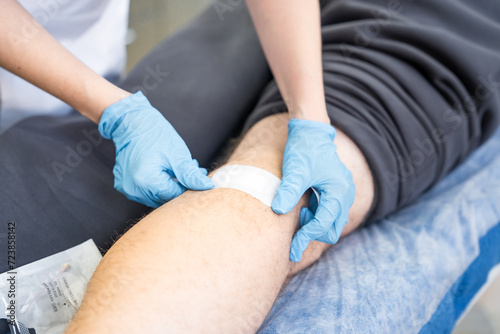 Medical worker doing wound treatment, close up view