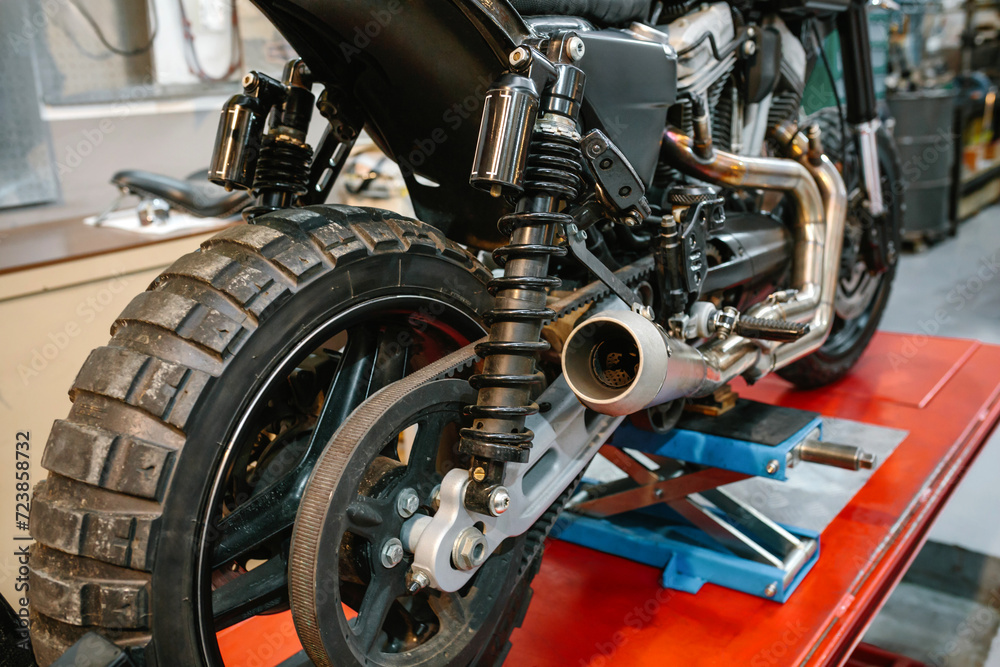 custom made wallpaper toronto digitalBack view of exhaust pipe and shock absorber of custom motorbike on factory. Close up of vintage scrambler motorcycle over platform ready to review on cleaned mechanic garage.