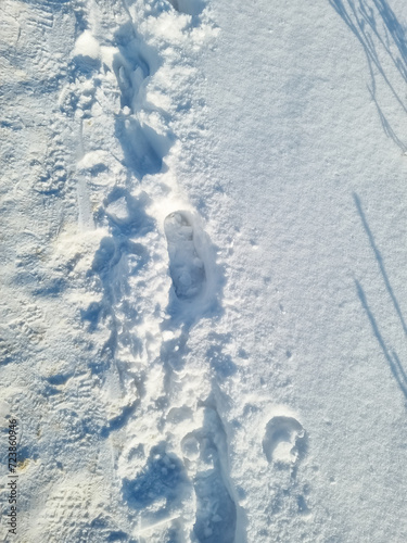 Close-up - shoe prints on a snowy path