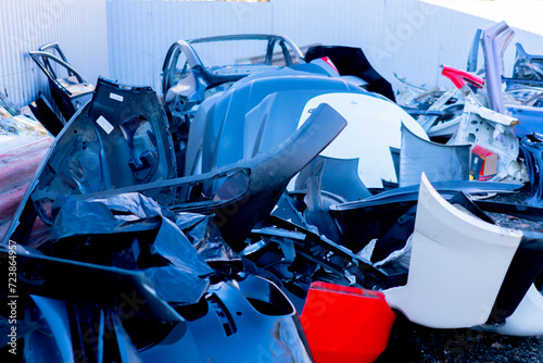 close-up of various metal spare parts from cars at the scrapyard car disposal station photo